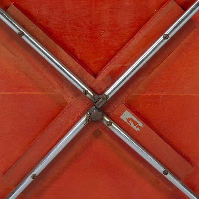 View of underside of red Eames CTM coffee table
