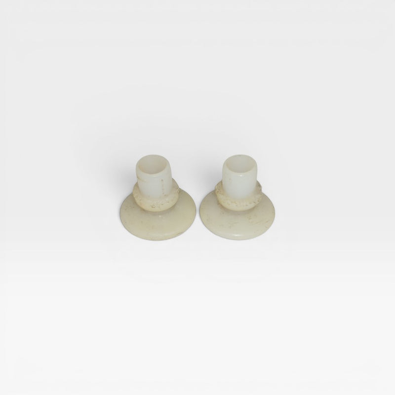 Front view of pair of white Eames nylon insert glide feet for DSS, H Base Chairs