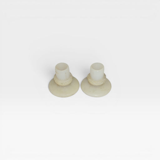 Front view of pair of white Eames nylon insert glide feet for DSS, H Base Chairs