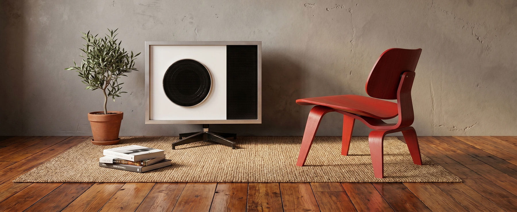 A red Eames LCW chair stand with an Eames Speaker made for Stephens Trusonic on a wooden floor and rug