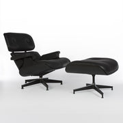 Right side angled view of all black Eames lounge chair and ottoman