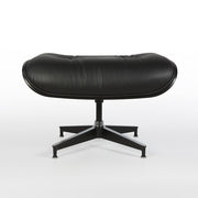 Front view of all black Eames lounge ottoman