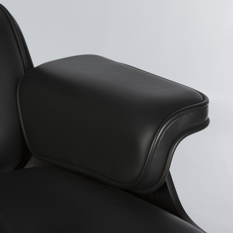 Close up view of arm on all black Eames lounge chair