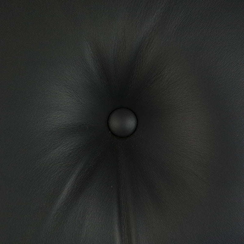 View of leather on all black Eames lounge chair and ottoman