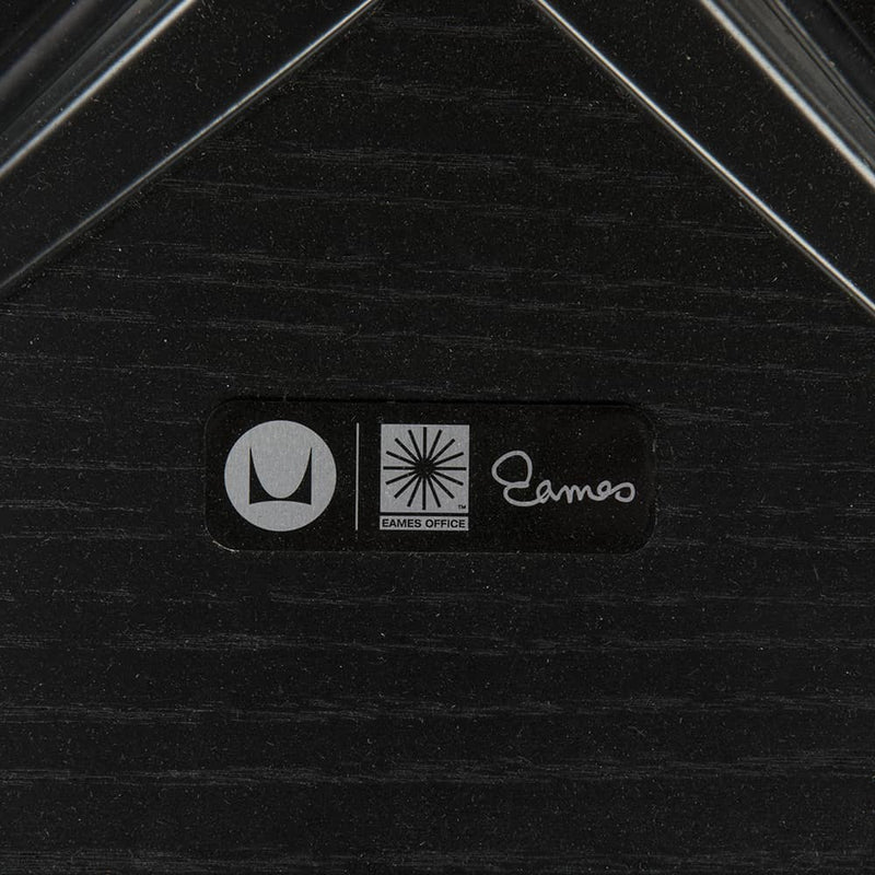 View of label on all black Eames lounge chair and ottoman