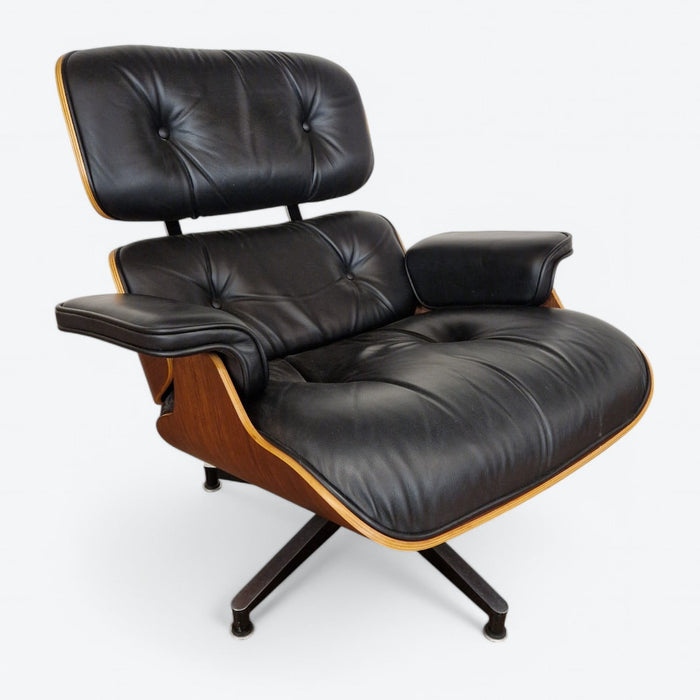 Front angled view of black and walnut Eames Lounge Chair