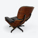 Rear left side angled view of black and walnut Eames Lounge Chair