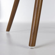 Close up view of lower legs on light oak Eames dowel base