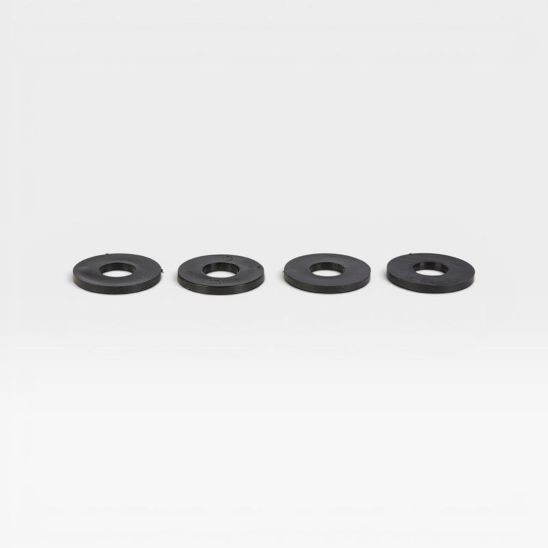 Four large black plastic washers for use on Eames upholstered fiberglass chairs