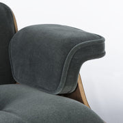 View of arm on green mohair walnut Eames Lounge Chair