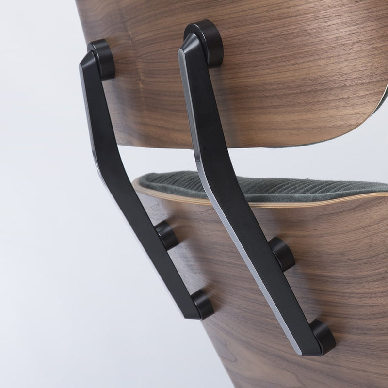Angled close up rear view of green mohair walnut Eames Lounge Chair