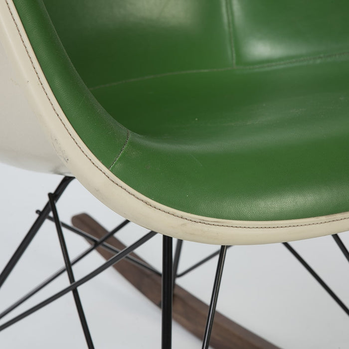 Close up front angled view of green on greige Eames RAR rocking arm chair