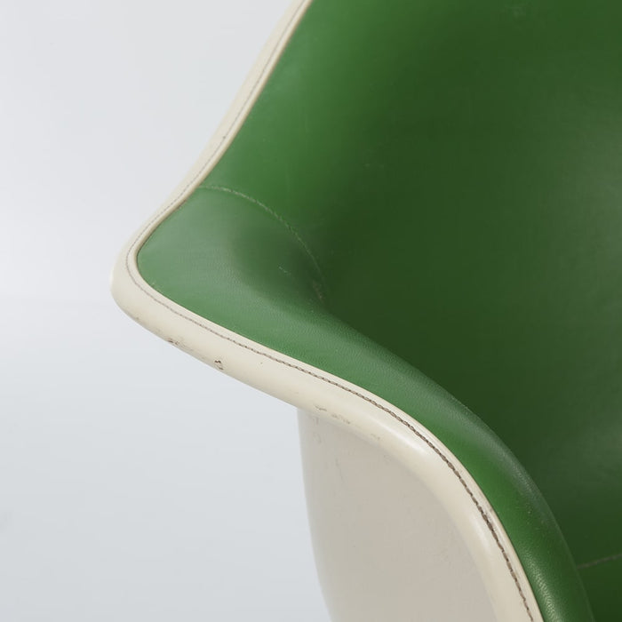 Close up view of arm on green on greige Eames RAR rocking arm chair