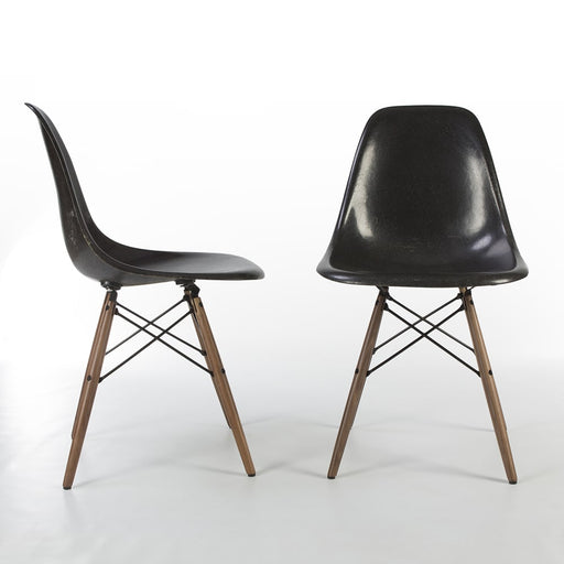 View of pair of black Eames DSWs, one from front, one from right side