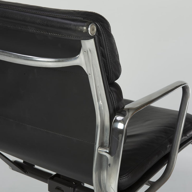 Close up rear angled view of black Eames EA435 office chair