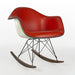Front angled view of red Eames RAR rocking arm chair