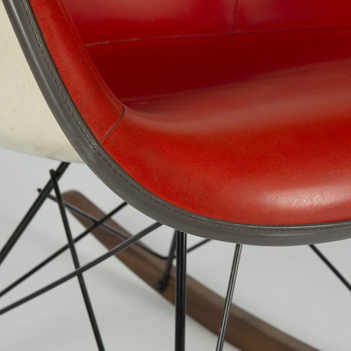 Close up front angled view of red Eames RAR rocking arm chair
