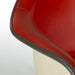 Close up view of arm on red Eames RAR rocking arm chair