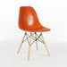 Front angled view of orange Eames DSW dining side chair