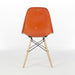 Rear view of orange Eames DSW dining side chair