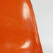 Close up front view of orange Eames DSW dining side chair