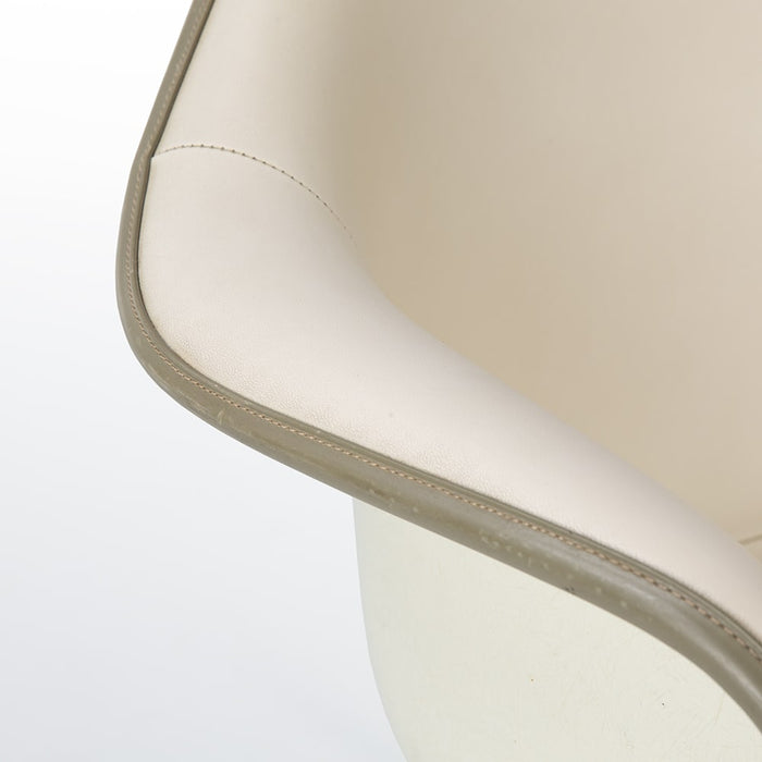 Close up arm view of all white Eames RAR rocking arm chair