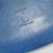 View of logo on blue Eames DSW dining side chair
