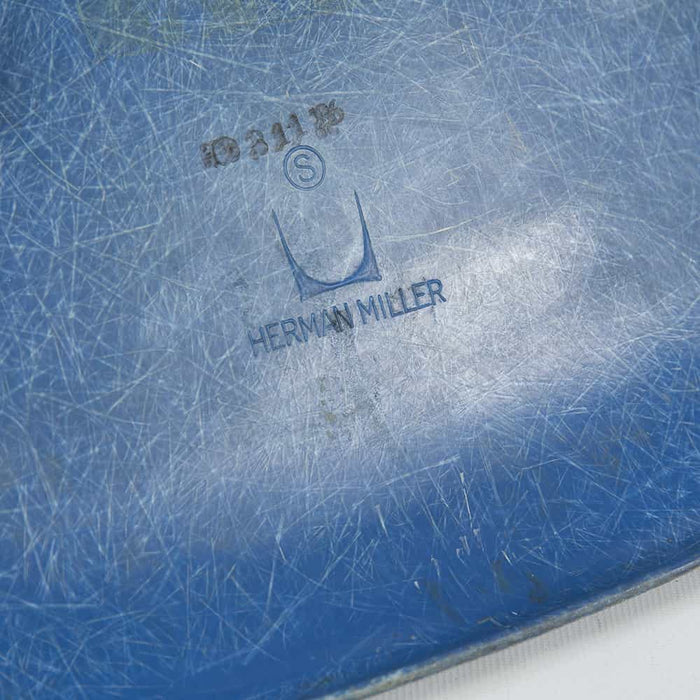 View of logo on blue Eames DSW dining side chair
