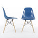 View of pair of blue Eames DSW dining side chairs, one from the right, one from the front