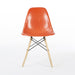 Front view of orange Eames DSW dining side chair
