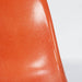 Close up front view of orange Eames DSW dining side chair