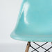 Partial front view of turquoise Eames DSW dining chair