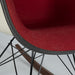 Close up front angled view of red fabric Eames RAR rocking arm chair