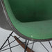 Close up front angled view of green on black Eames RAR rocking arm chair