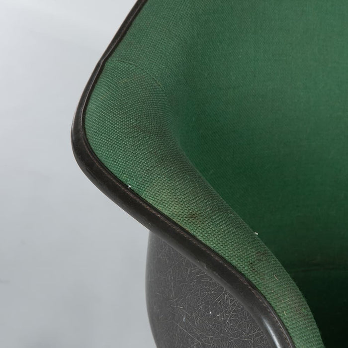 Close up view of arm on green on black Eames RAR rocking arm chair
