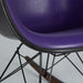 Close up front angled view of purple and black Eames RAR rocking arm chair