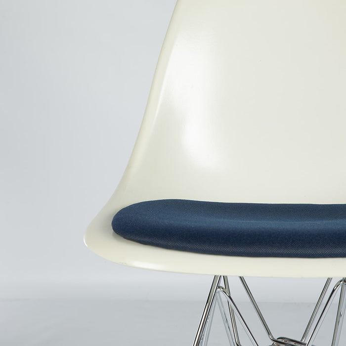 Artistic front angled view of white and blue Eames DFSR dining side chair