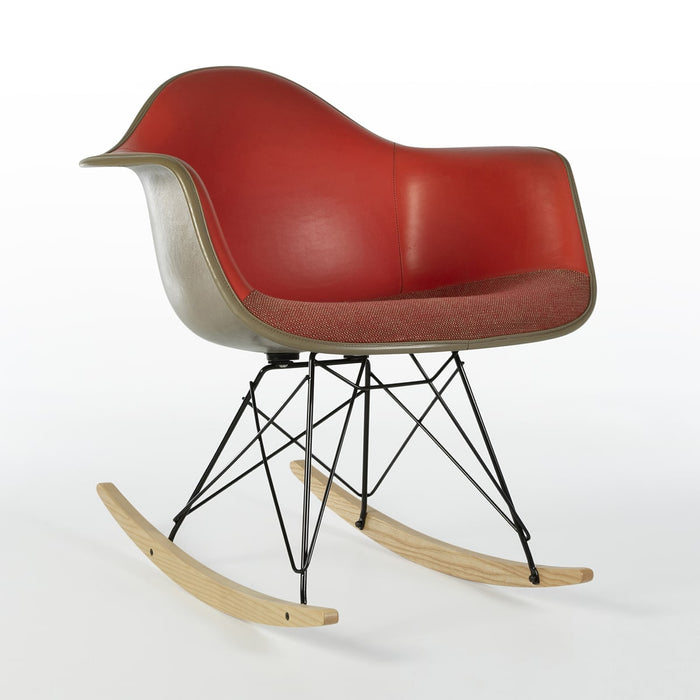 Front angled view of red vinyl Eames RAR rocking arm chair