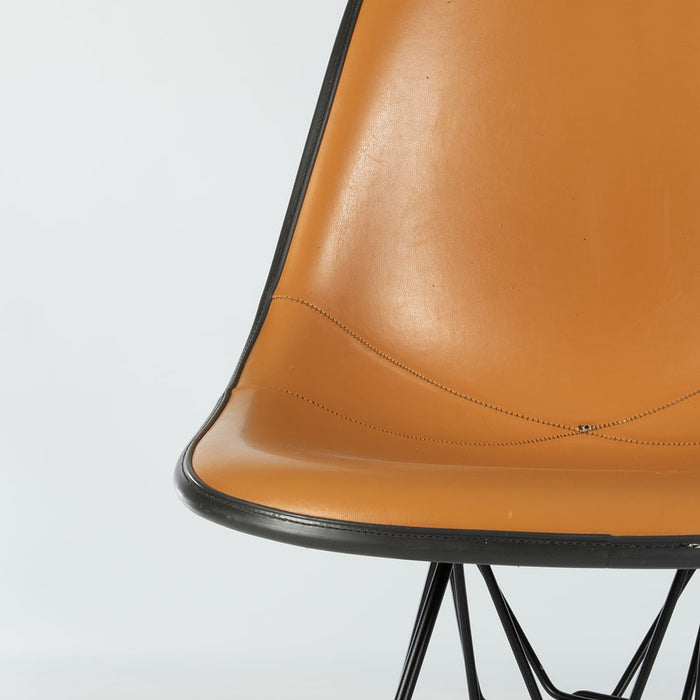 Partial front view of Orange and Black Eames DSR