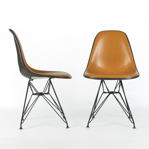 View of pair of Orange and Black Eames DSRs, one from right side, one from front