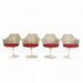 Front view of set of 4 white Saarinen Tulip Arm Chairs in a line