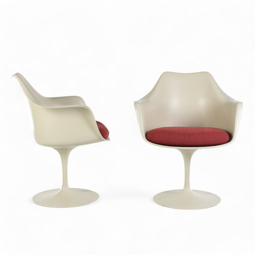 View of pair of White Saarinen Tulip Arm Chair, one from front, one from right side