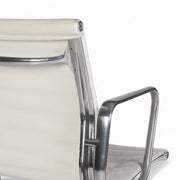 Close up rear angled view of white Eames EA335 office chair
