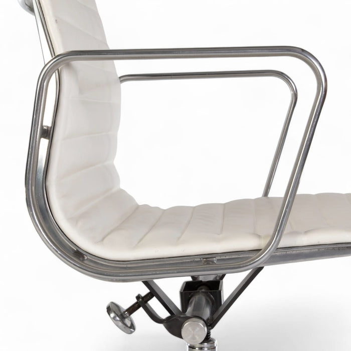 Close up right side view of white Eames EA335 office chair