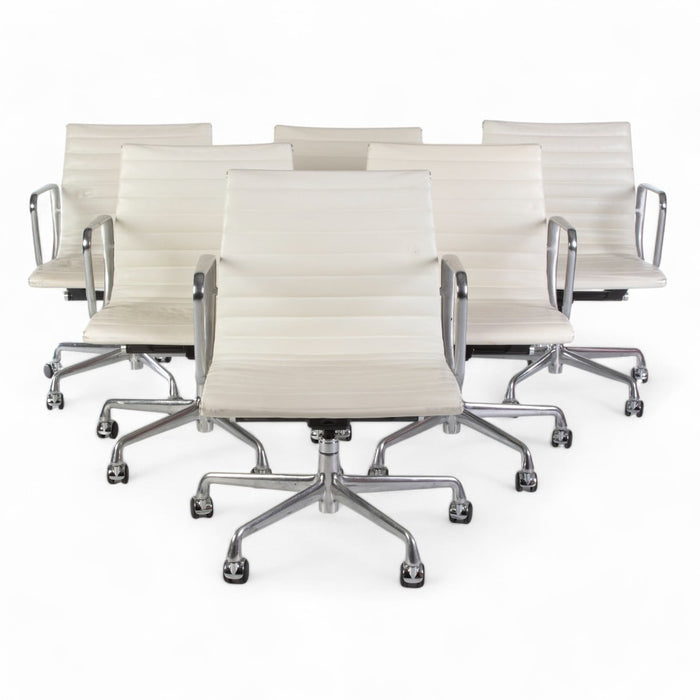 View of set of 6 white Eames EA335 office chairs in a triangle