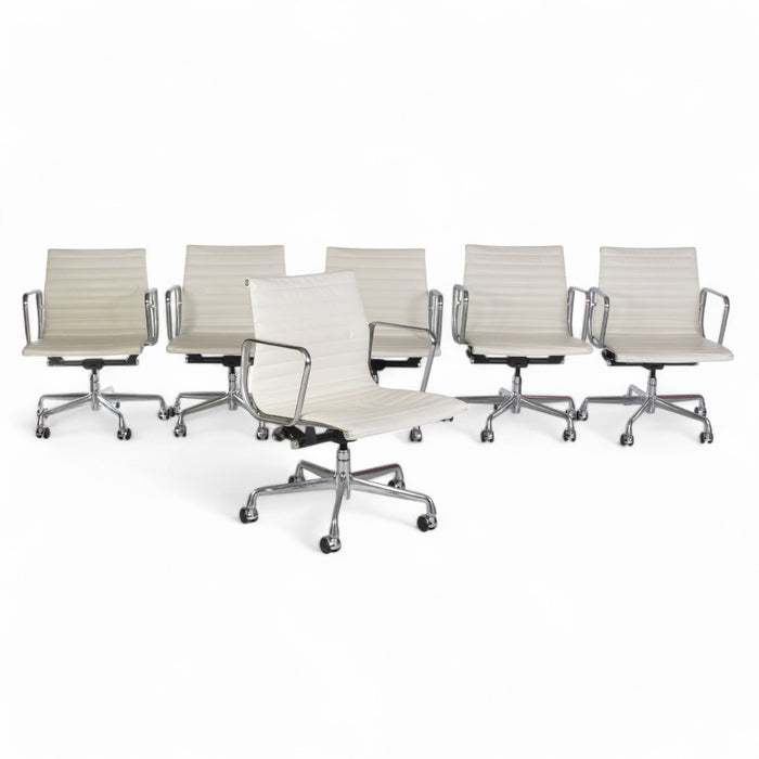 View of set of 6 white Eames EA335 office chairs in a line