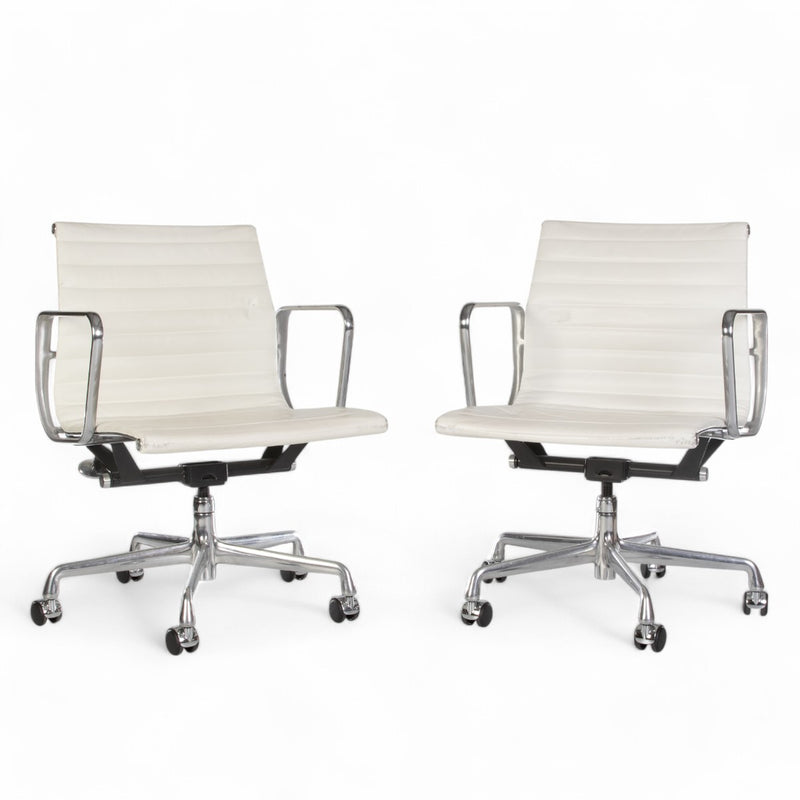 Front view of pair of white Eames EA335 office chairs