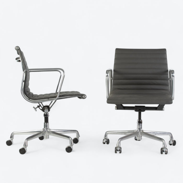 View of pair of dark grey Eames EA335, one from right side, one from front