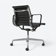 Rear angled view of black Eames EA318 office chair