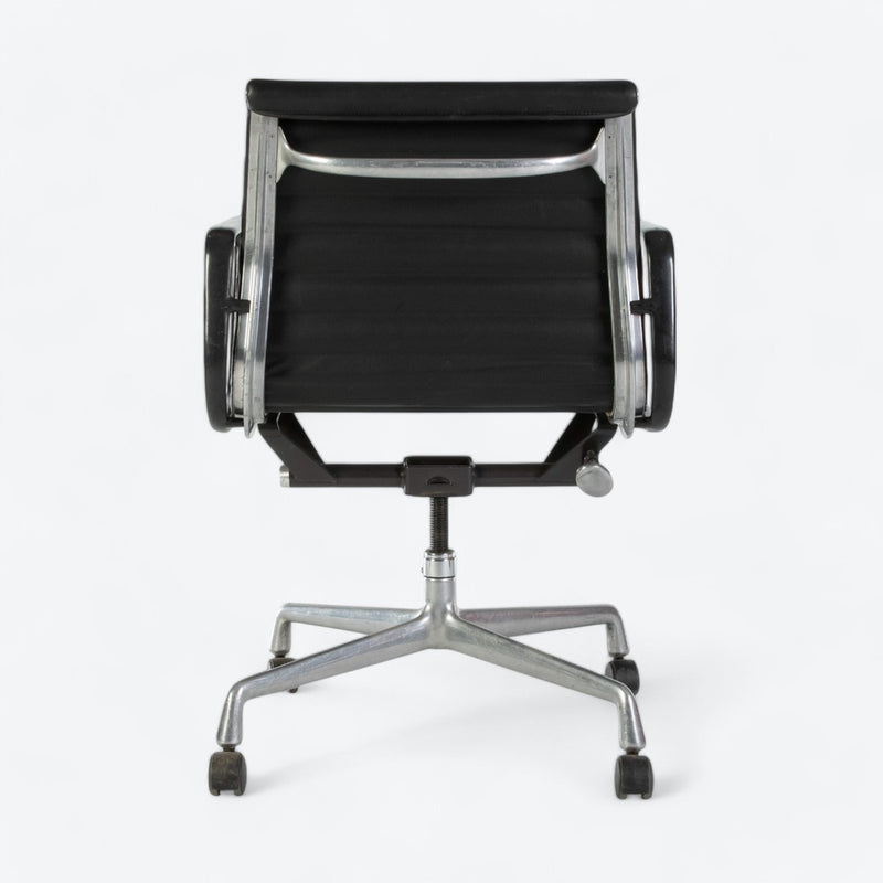 Rear view of black Eames EA318 office chair